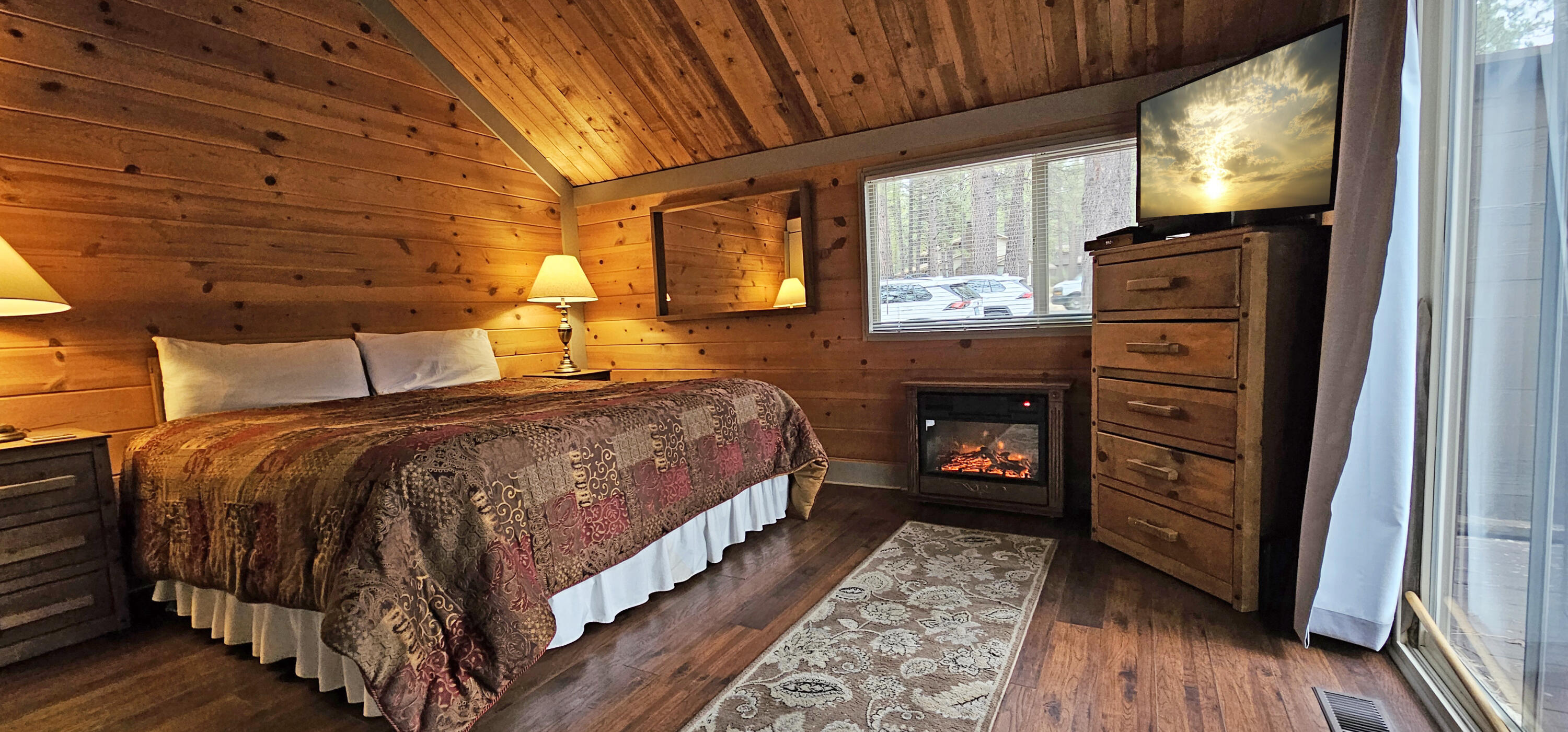 57397 Overlook Road Sunriver, OR 97707 - Photo 7 of 23 This cozy suite on the main floor offers the perfect retreat for restful nights, featuring an inviting electric fireplace for added comfort.
