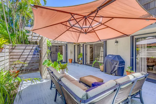 a living room with furniture a flat screen tv and a floor to ceiling window