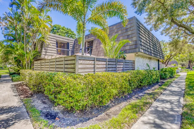 a view of a house with a yard and a garden
