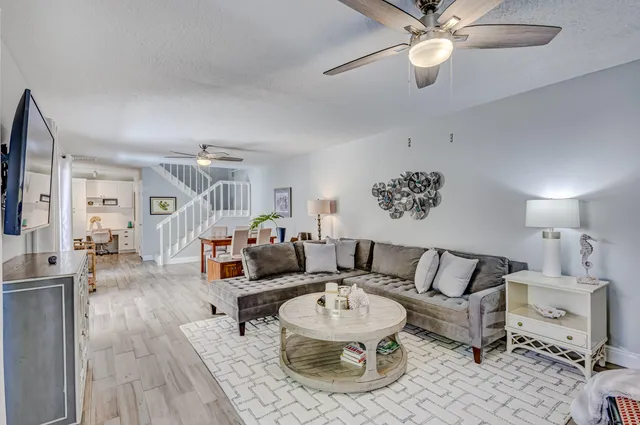 a kitchen with granite countertop white cabinets sink and stainless steel appliances