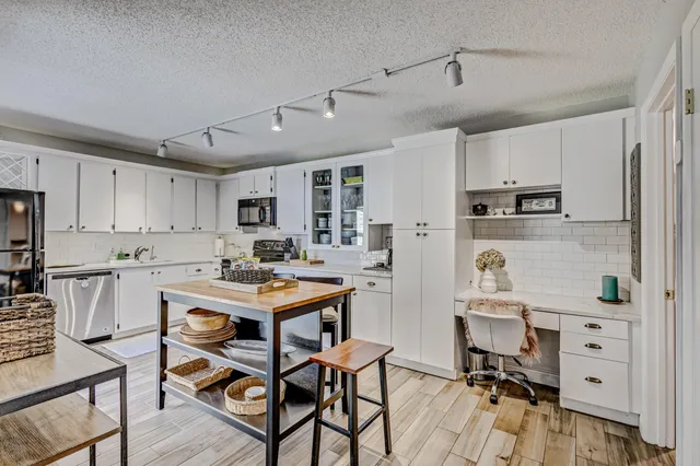 a bathroom with a granite countertop toilet sink and mirror
