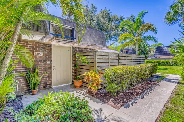 a view of a patio with table and chairs and potted plants