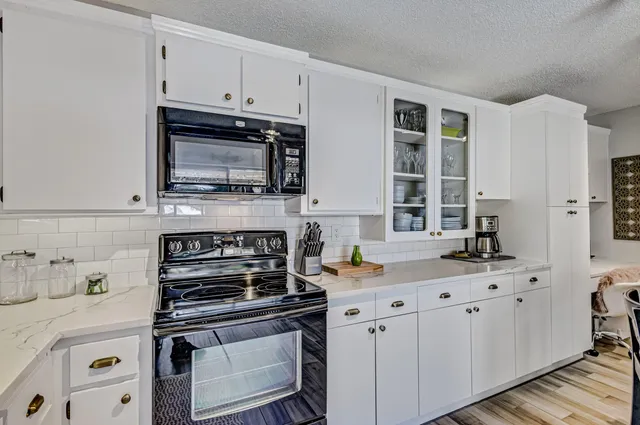 a bathroom with a granite countertop sink a mirror a glass door a shower and a mirror