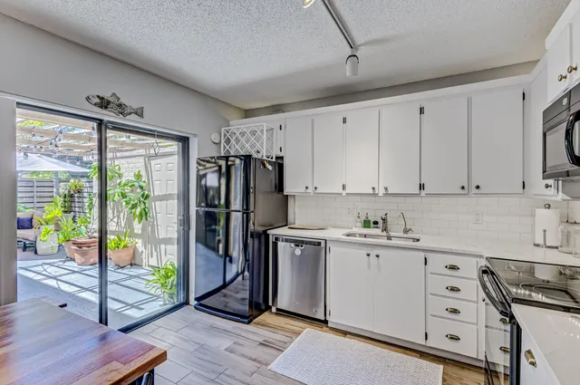 a spacious bathroom with a granite countertop sink mirror and shower