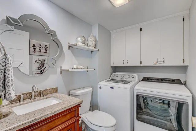 a spacious bathroom with a granite countertop sink mirror and double