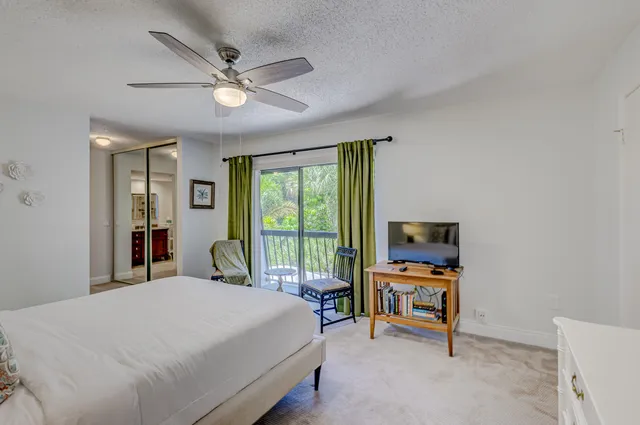a bathroom with a toilet a shower and a window