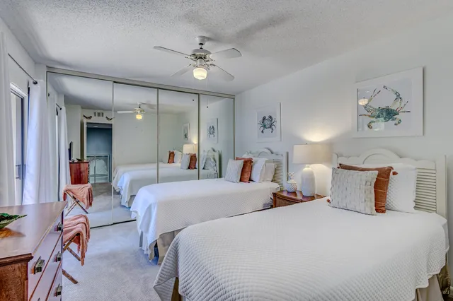 an aerial view of a house with a yard and large trees