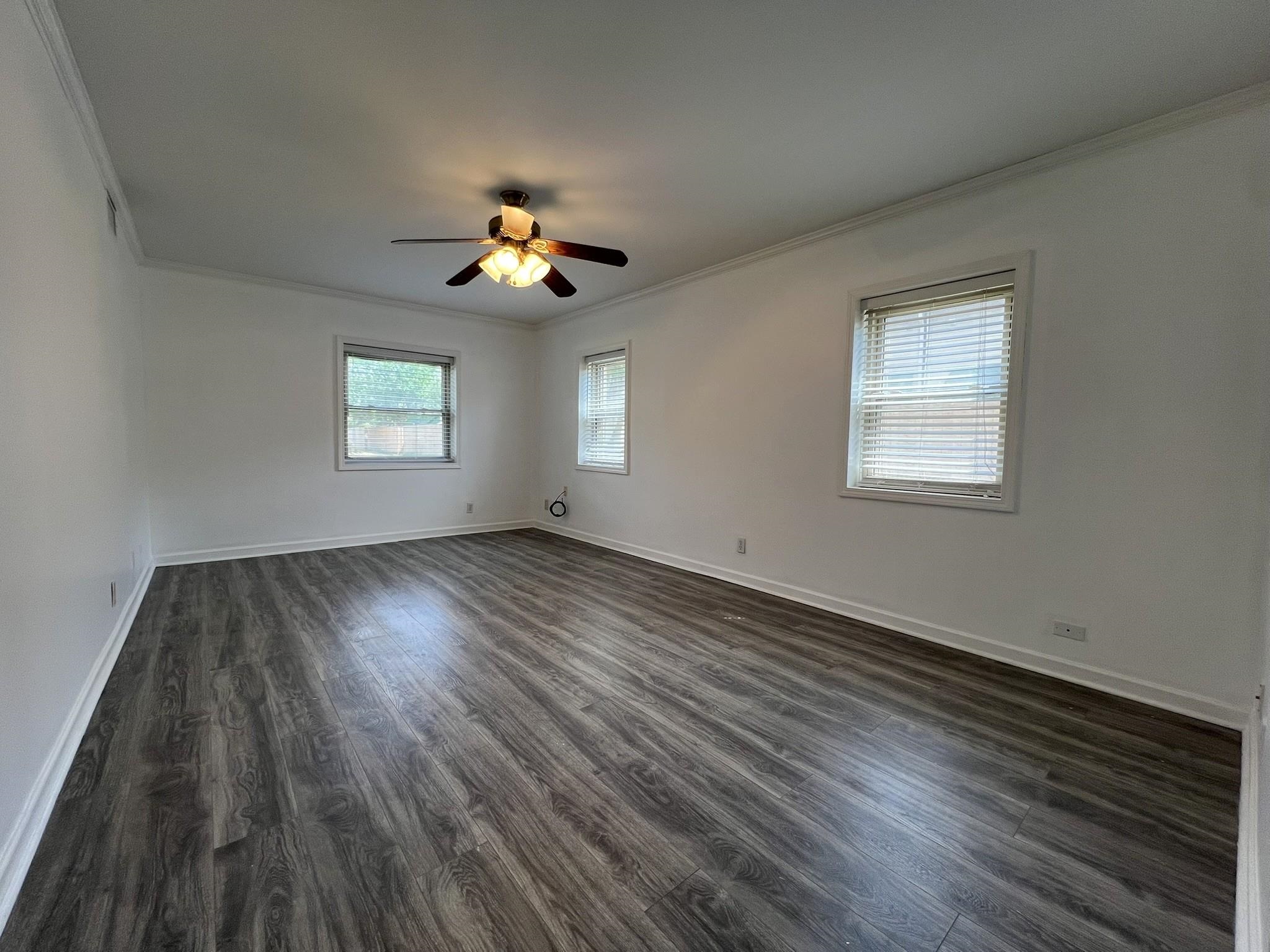 1207 Middle Court, Unit 102 Memphis, TN 38119 - Photo 11 of 31 a view of an empty room with a window and wooden floor