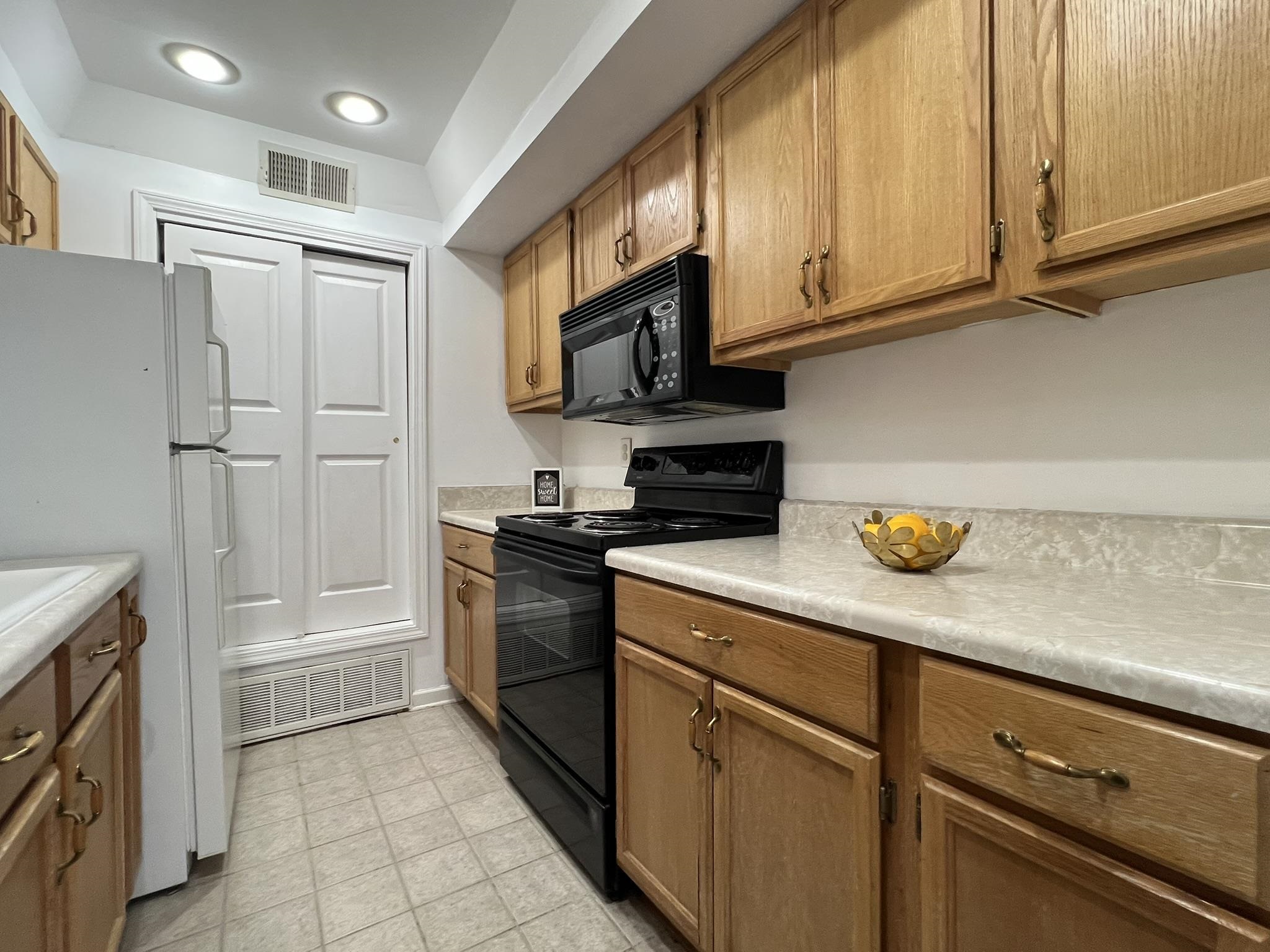 1207 Middle Court, Unit 102 Memphis, TN 38119 - Photo 16 of 31 a kitchen with stainless steel appliances granite countertop a refrigerator and a stove