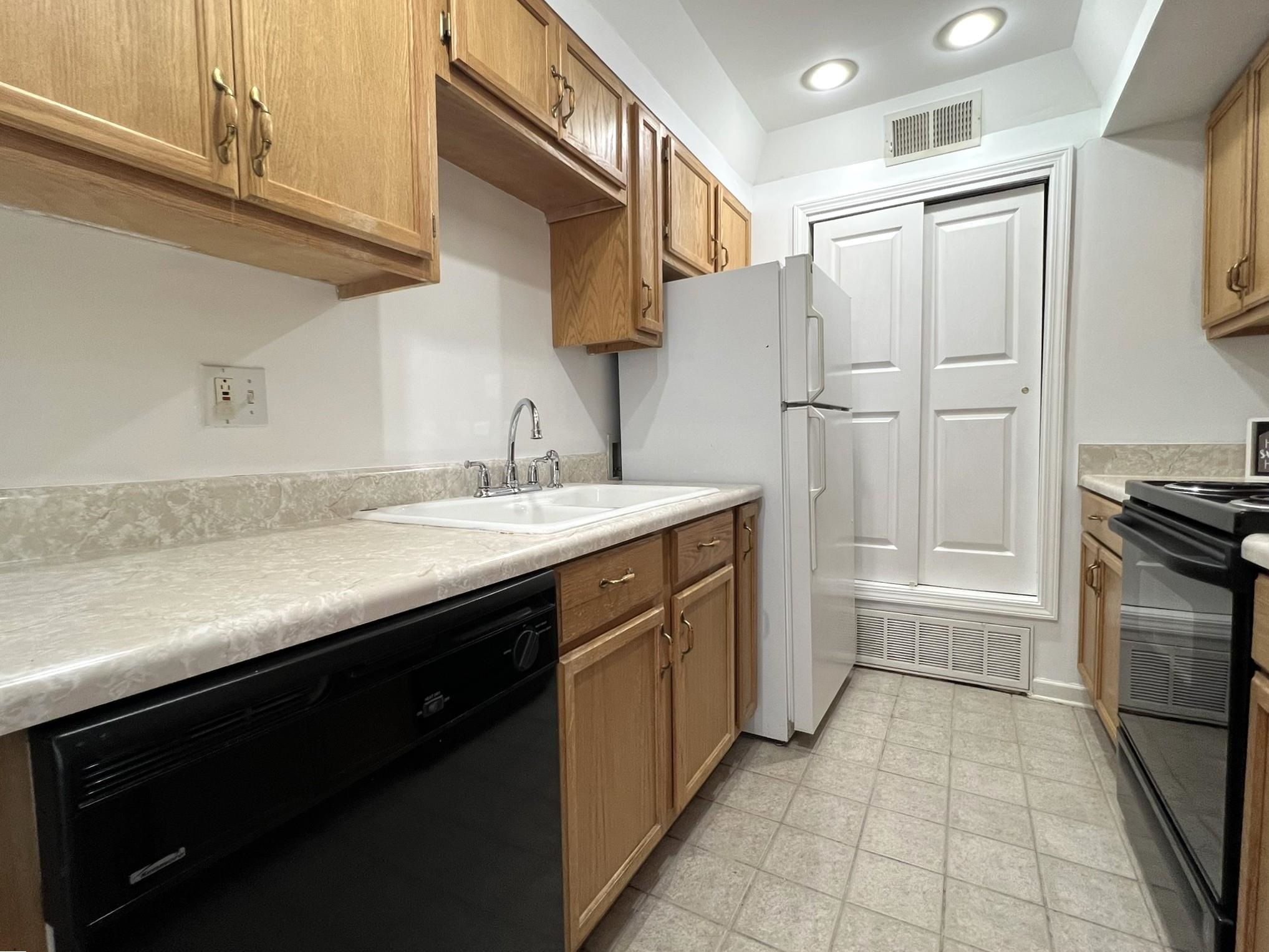 1207 Middle Court, Unit 102 Memphis, TN 38119 - Photo 17 of 31 a kitchen with a sink appliances and cabinets