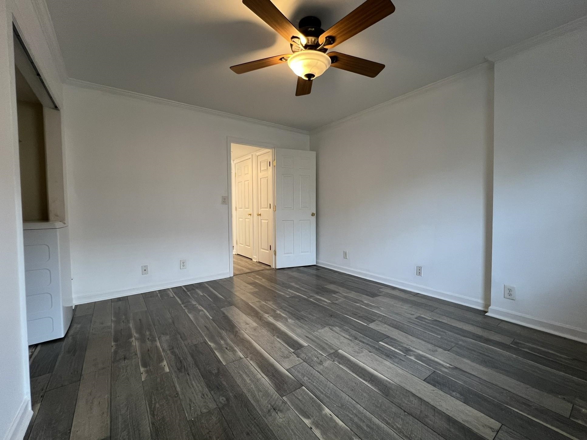 1207 Middle Court, Unit 102 Memphis, TN 38119 - Photo 21 of 31 a view of empty room with wooden floor and fan