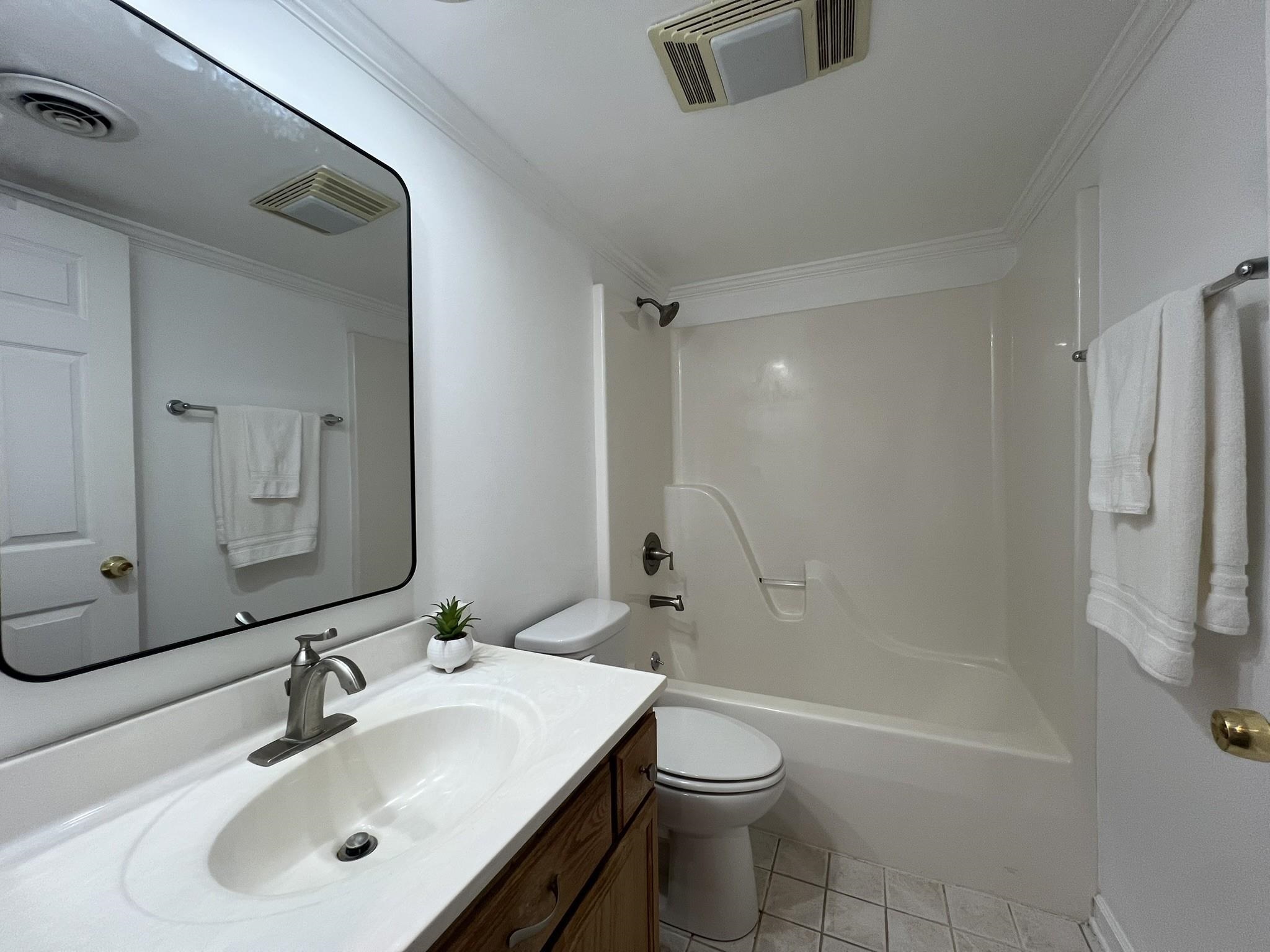 1207 Middle Court, Unit 102 Memphis, TN 38119 - Photo 22 of 31 a bathroom with a sink toilet and shower