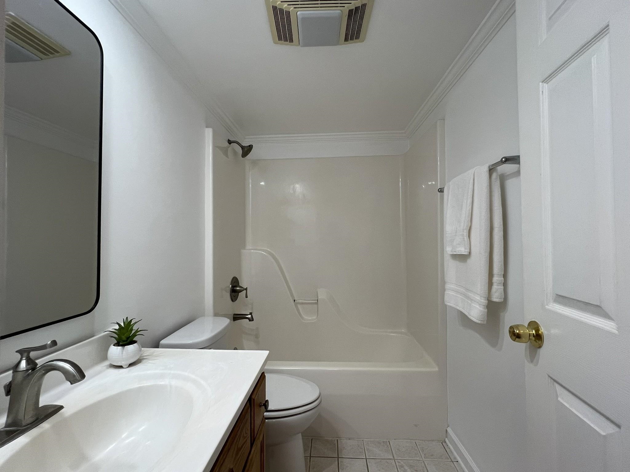 1207 Middle Court, Unit 102 Memphis, TN 38119 - Photo 23 of 31 a bathroom with a sink a toilet and shower