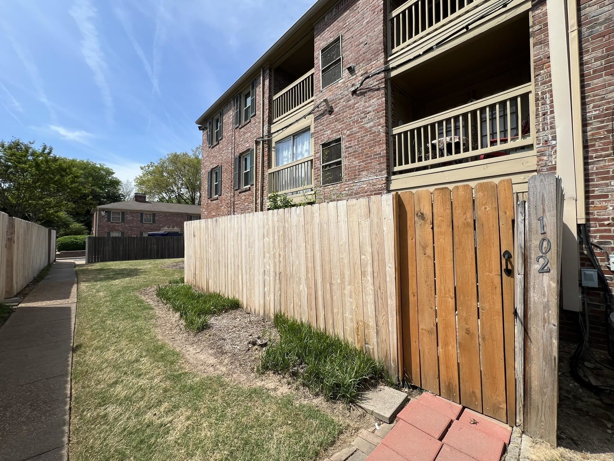 1207 Middle Court, Unit 102 Memphis, TN 38119 - Photo 27 of 31 a view of a house with a wooden fence