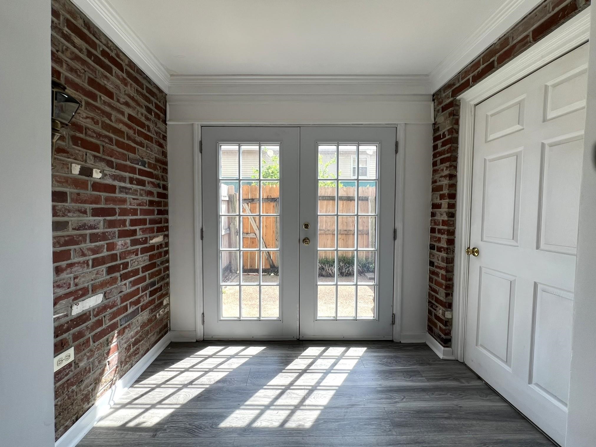 1207 Middle Court, Unit 102 Memphis, TN 38119 - Photo 7 of 31 a view of an empty room with wooden floor and a window
