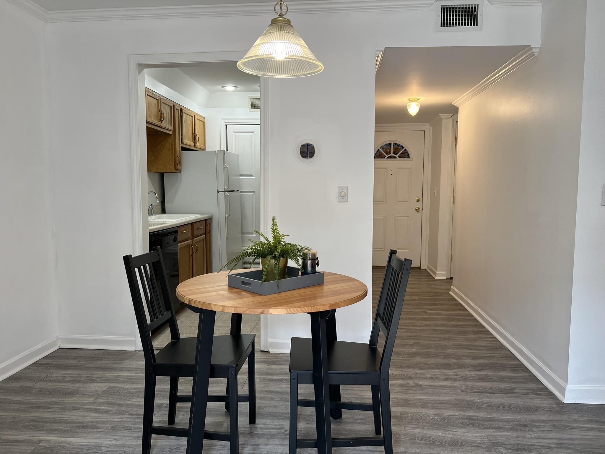 1207 Middle Court, Unit 102 Memphis, TN 38119 - Photo 8 of 31 a view of a dining room with furniture and wooden floor