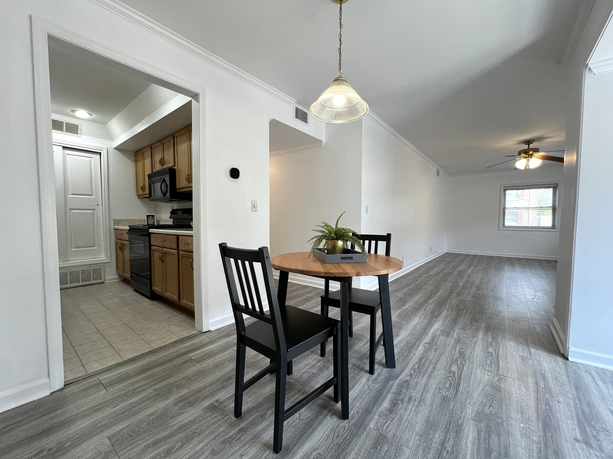 1207 Middle Court, Unit 102 Memphis, TN 38119 - Photo 10 of 31 a view of a dining room with furniture window and wooden floor