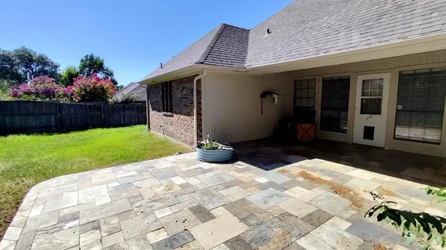 a view of a house with a yard and flowers