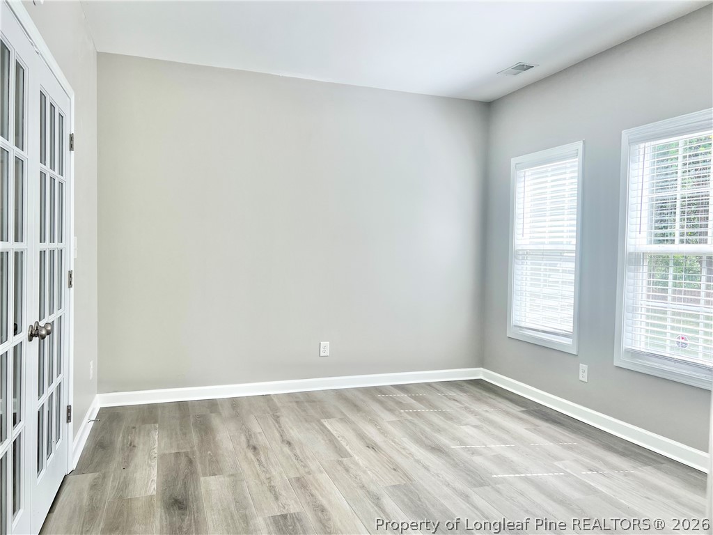 1523 Rough Rider Lane Parkton, NC 28371 - Photo 22 of 42 an empty room with wooden floor and windows