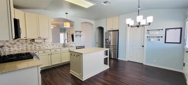 a bathroom with a sink vanity granite and a shower