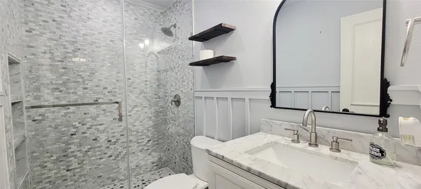 a bathroom with a sink toilet and shower