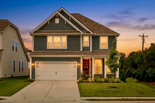 a front view of a house with a yard
