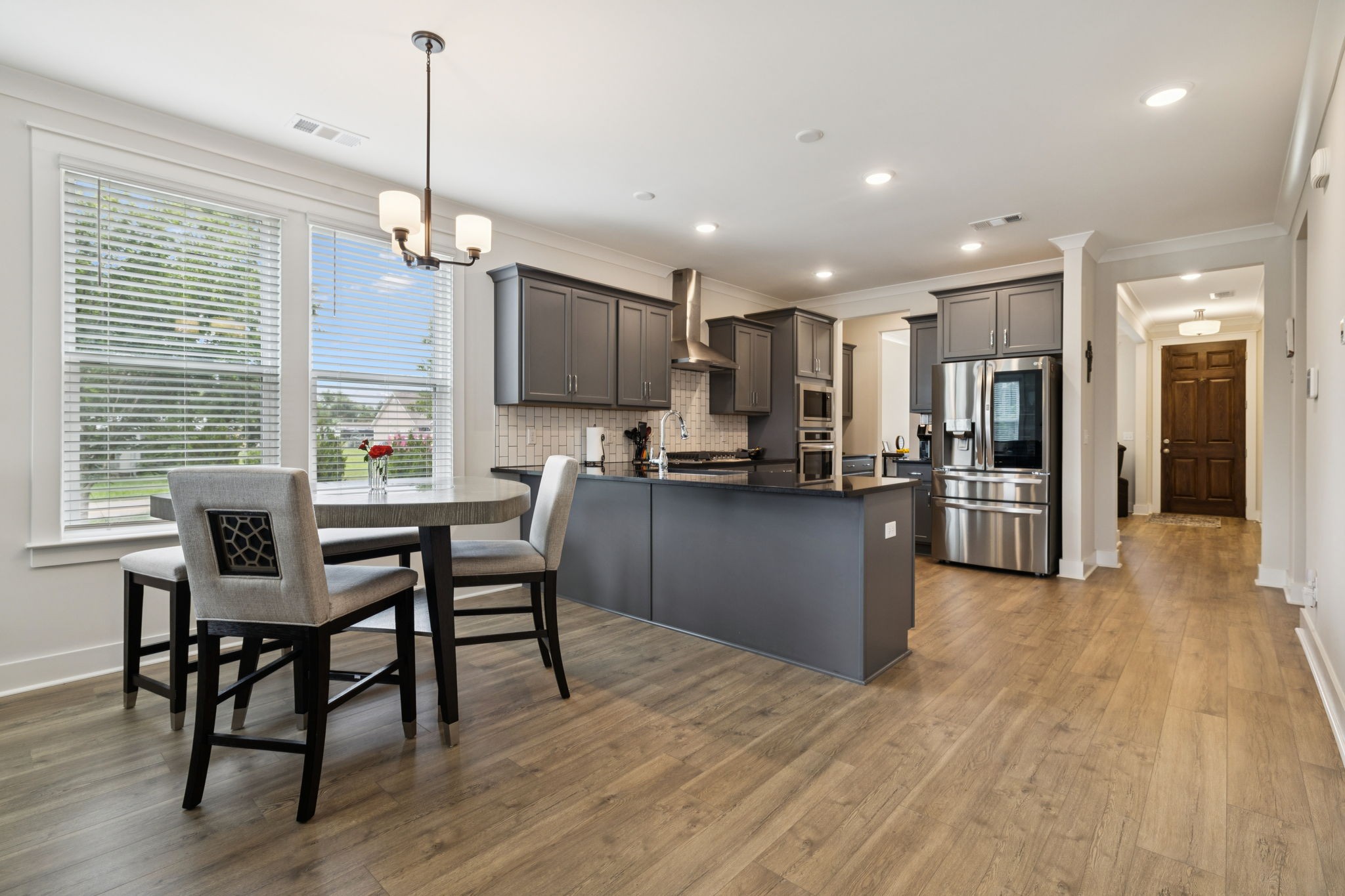 3737 Felipe Way Murfreesboro, TN 37129 - Photo 13 of 45 a kitchen with stainless steel appliances kitchen island granite countertop a table chairs and a refrigerator