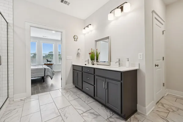 a spacious bathroom with a double vanity sink mirror and toilet
