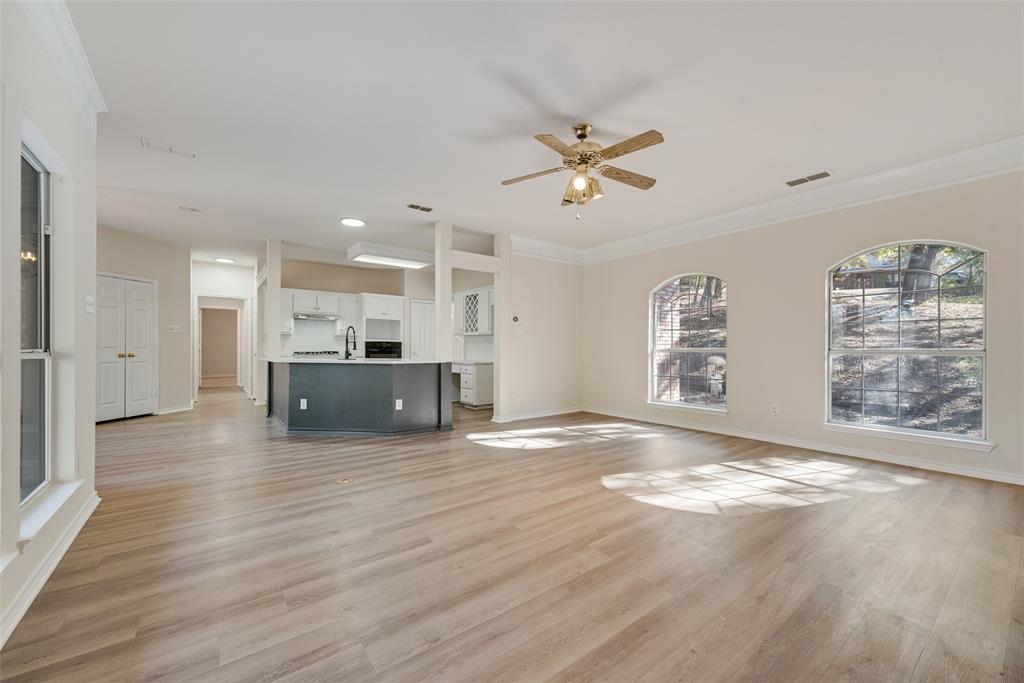 421 Roland Drive Keller, TX 76248 - Photo 11 of 40 a view of kitchen and hall with wooden floor and a window