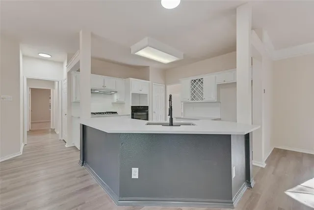 a kitchen with stainless steel appliances a sink stove and cabinets