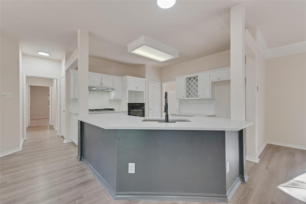 421 Roland Drive Keller, TX 76248 - Photo 14 of 40 a kitchen with stainless steel appliances a sink stove and cabinets