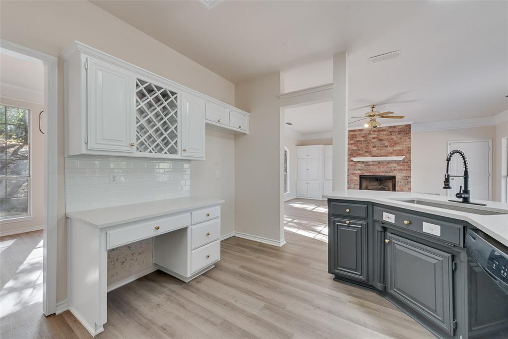 421 Roland Drive Keller, TX 76248 - Photo 16 of 40 a kitchen with white cabinets and sink