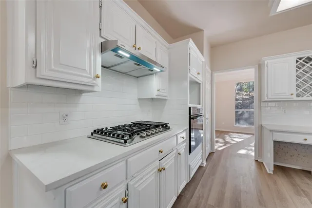 a spacious bathroom with a granite countertop double vanity sink and a mirror