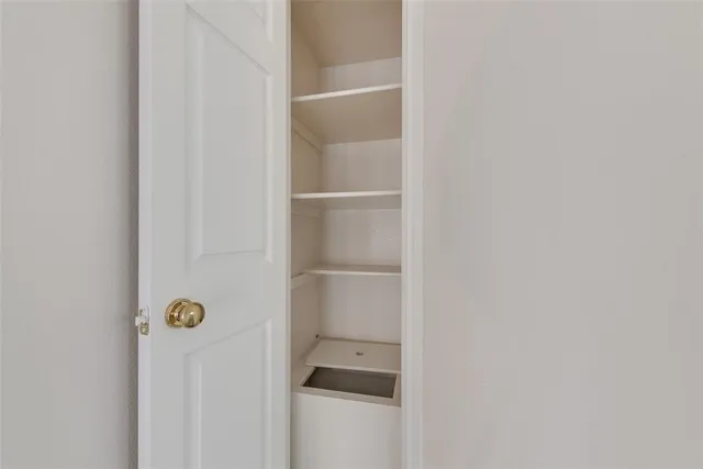 a view of an empty room with a ceiling fan
