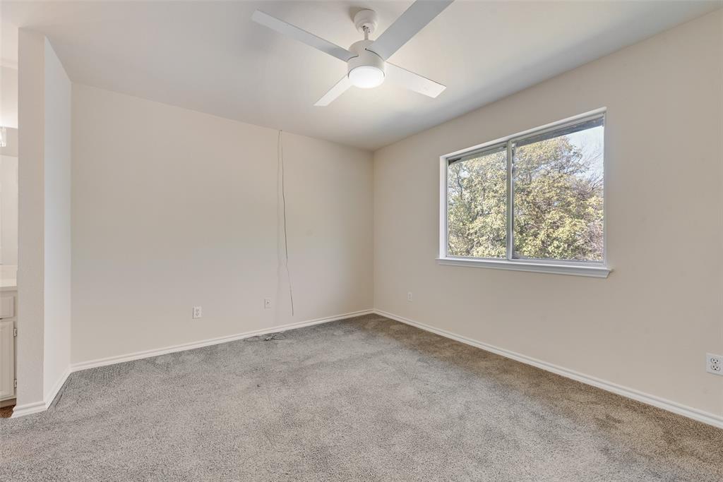 421 Roland Drive Keller, TX 76248 - Photo 21 of 40 an empty room with a window and a ceiling fan