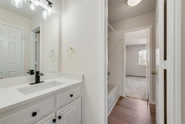 a bathroom with a sink a shower and a mirror