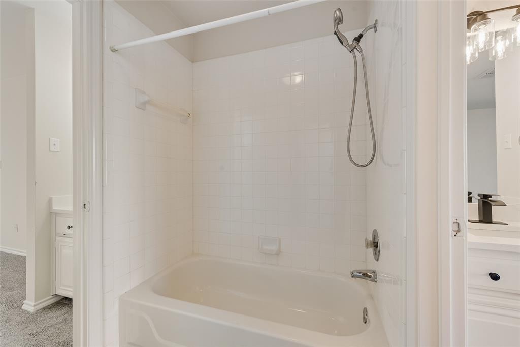 421 Roland Drive Keller, TX 76248 - Photo 25 of 40 a bathroom with a bath tub with a shower