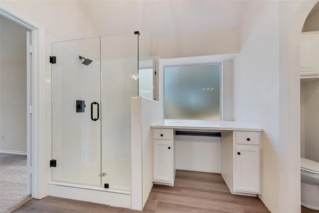 a spacious bathroom with a double vanity sink mirror and shower