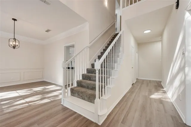 a view of entryway and hall with wooden floor