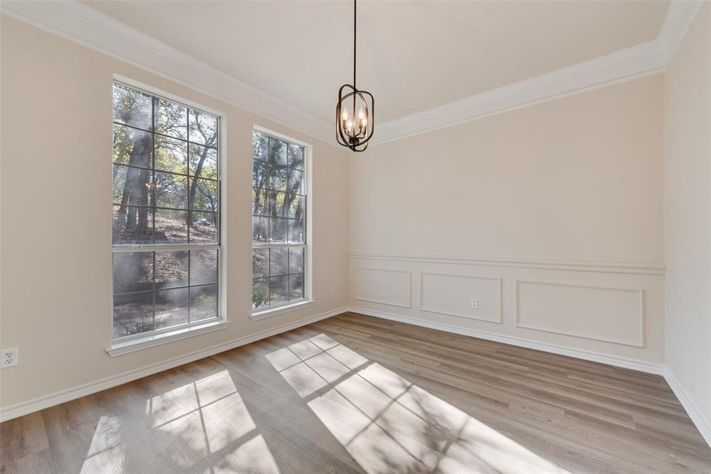 421 Roland Drive Keller, TX 76248 - Photo 8 of 40 a view of an empty room with wooden floor and a window