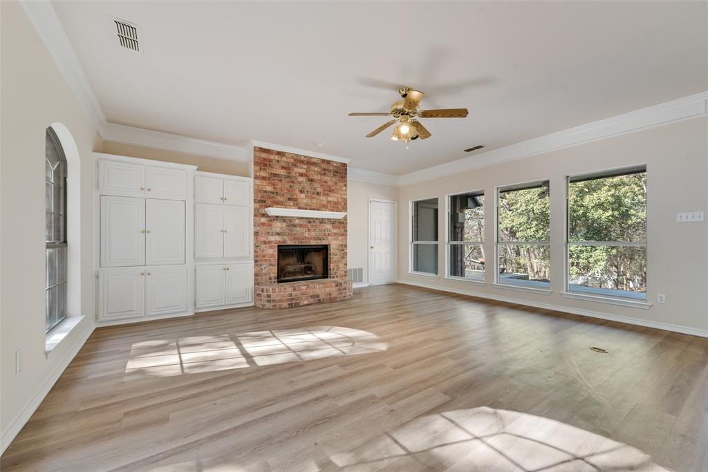 421 Roland Drive Keller, TX 76248 - Photo 10 of 40 a view of empty room with fireplace and fan