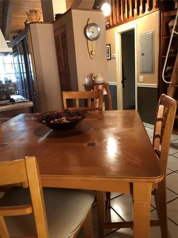 a view of a dining room with furniture and a chandelier
