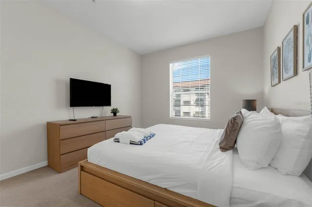 a bedroom with a bed and lamp