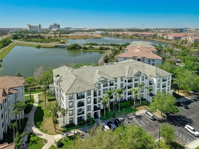 an aerial view of residential houses with outdoor space and river