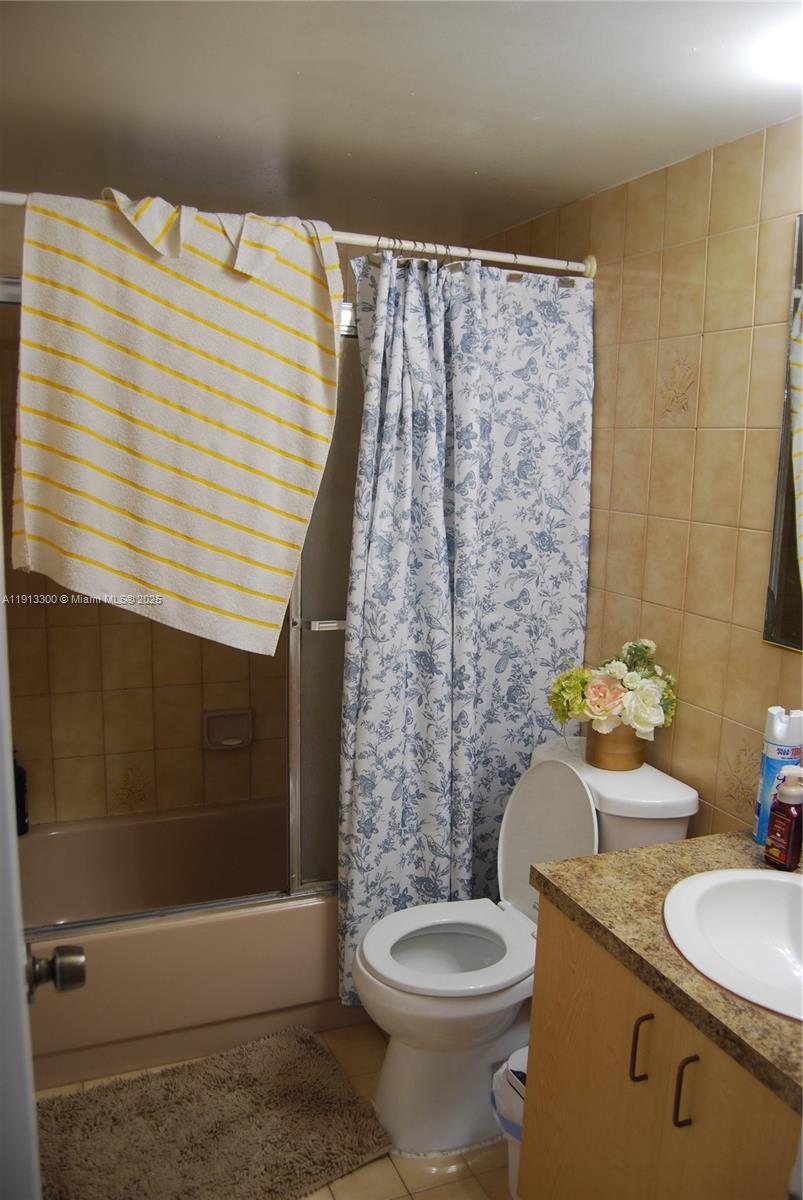 950 Southwest 13th Court Miami, FL 33135 - Photo 7 of 10 a bathroom with a granite countertop toilet a sink and a shower