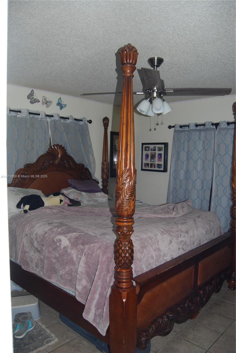 950 Southwest 13th Court Miami, FL 33135 - Photo 9 of 10 a bedroom with a bed and a chandelier