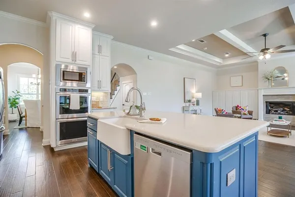 a kitchen with kitchen island a sink appliances and cabinets