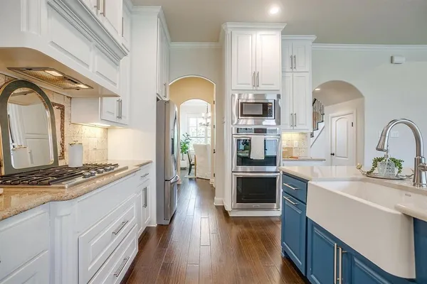 a kitchen with stainless steel appliances granite countertop a stove and a sink