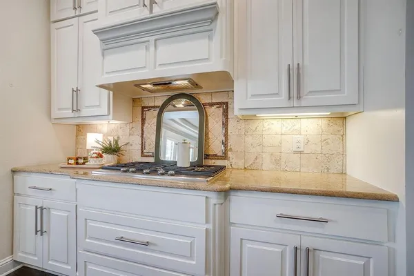 a sink with white cabinets