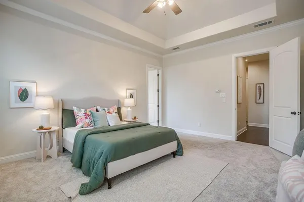 a bedroom with a bed and a lamp